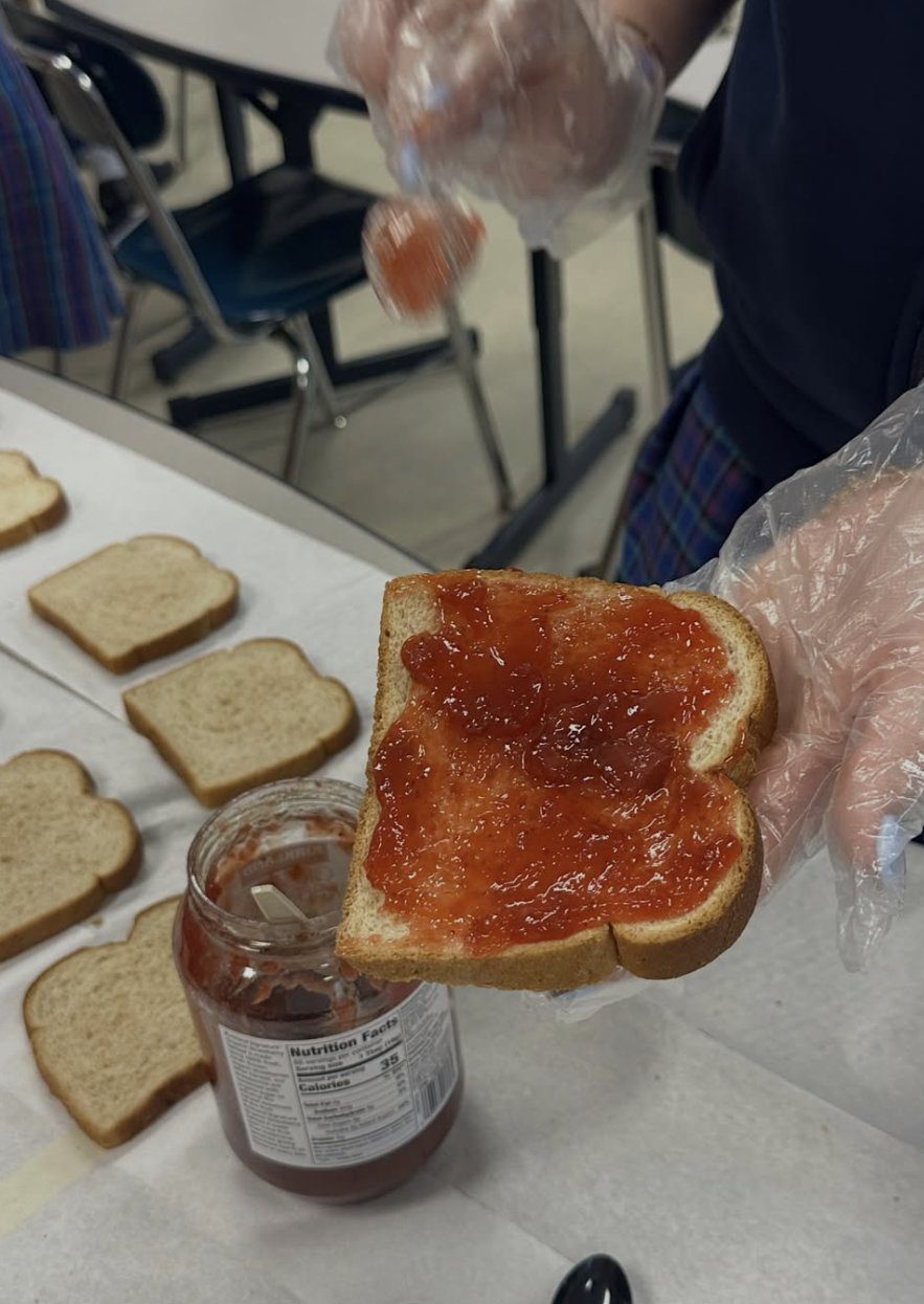A slice of bread spread with strawberry jam